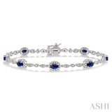 5x3 MM Oval Cut Sapphire and 1/20 Ctw Round Cut Diamond Bracelet in 14K White Gold